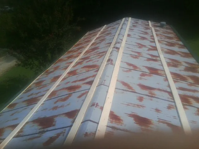 Rusted metal roof panels with new wood purlins before replacement — Storm Damage Roof Repair in Vincentown by Roofing Brothers