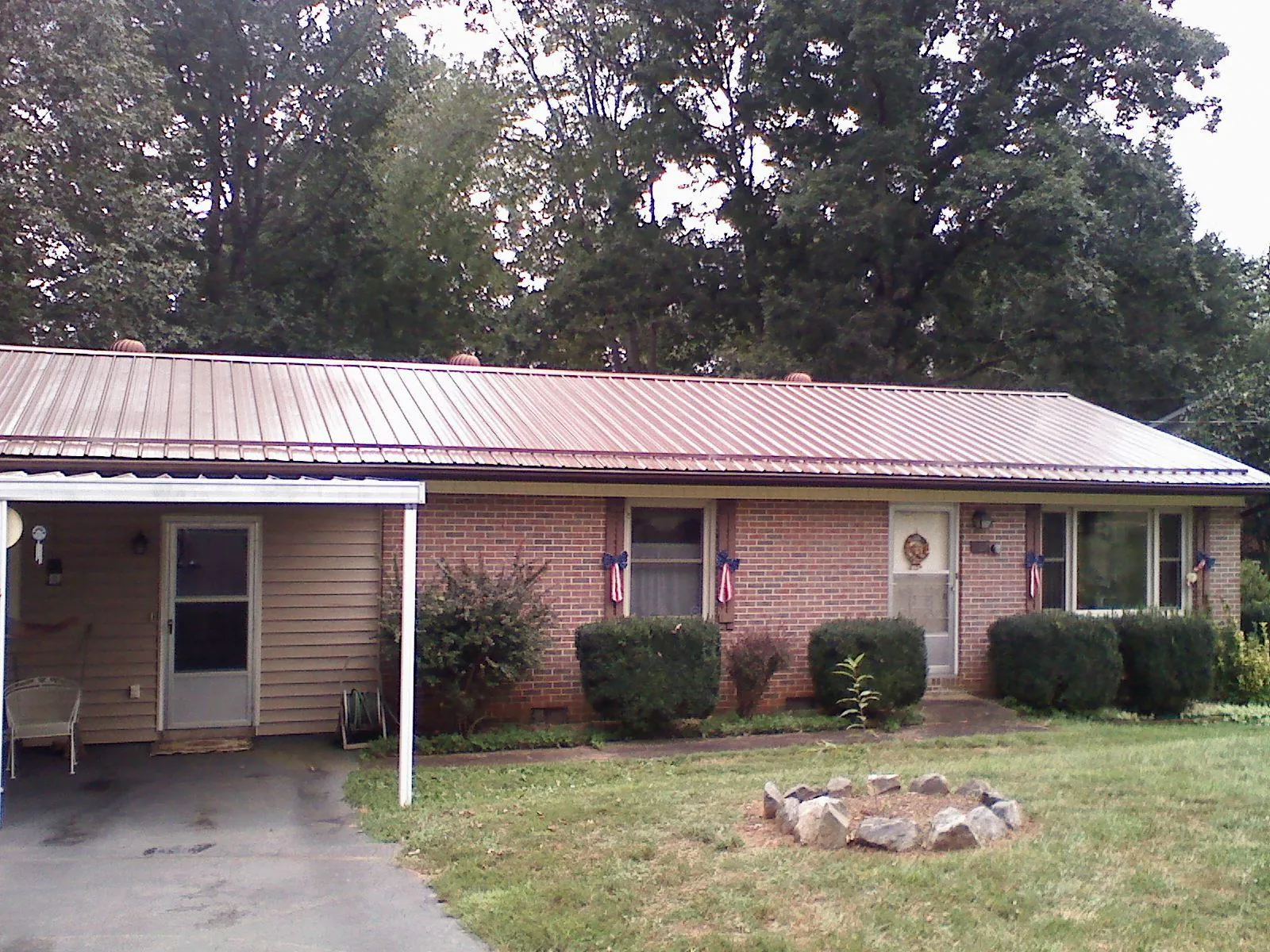 Bronze metal roof and carport on a brick ranch home — Roof Repair work by our crew in Vincentown